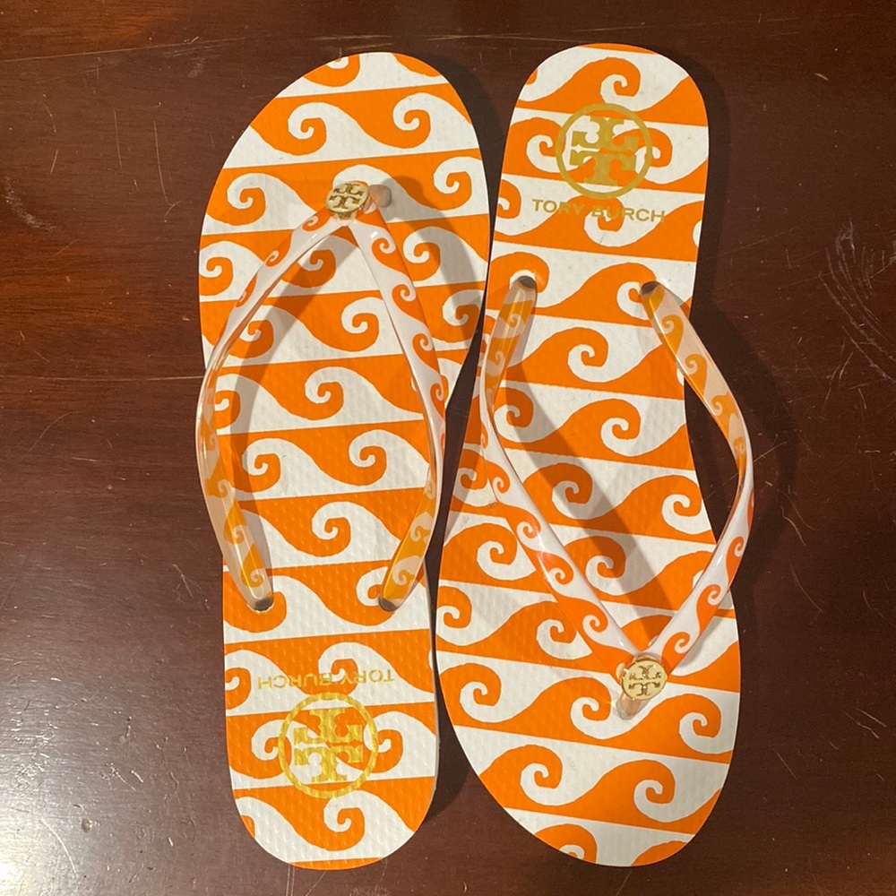 Tory Burch orange and white wave flip flops